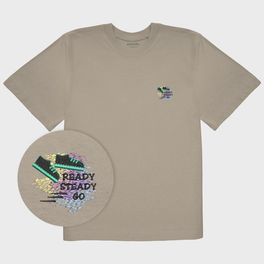 Unisex oversize mastic T-shirt with embroidered chest design, focus on design, outline drawing of a sneaker with motion lines in the background