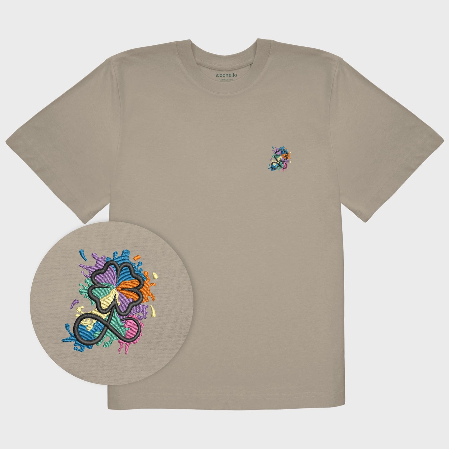 Unisex-T-Shirt Oversize mastic mit bestickter Brustpartie, Fokus auf Design, Kleeblatt-Infinity-Logo im mehrfarbigen Farbspritzer-Design