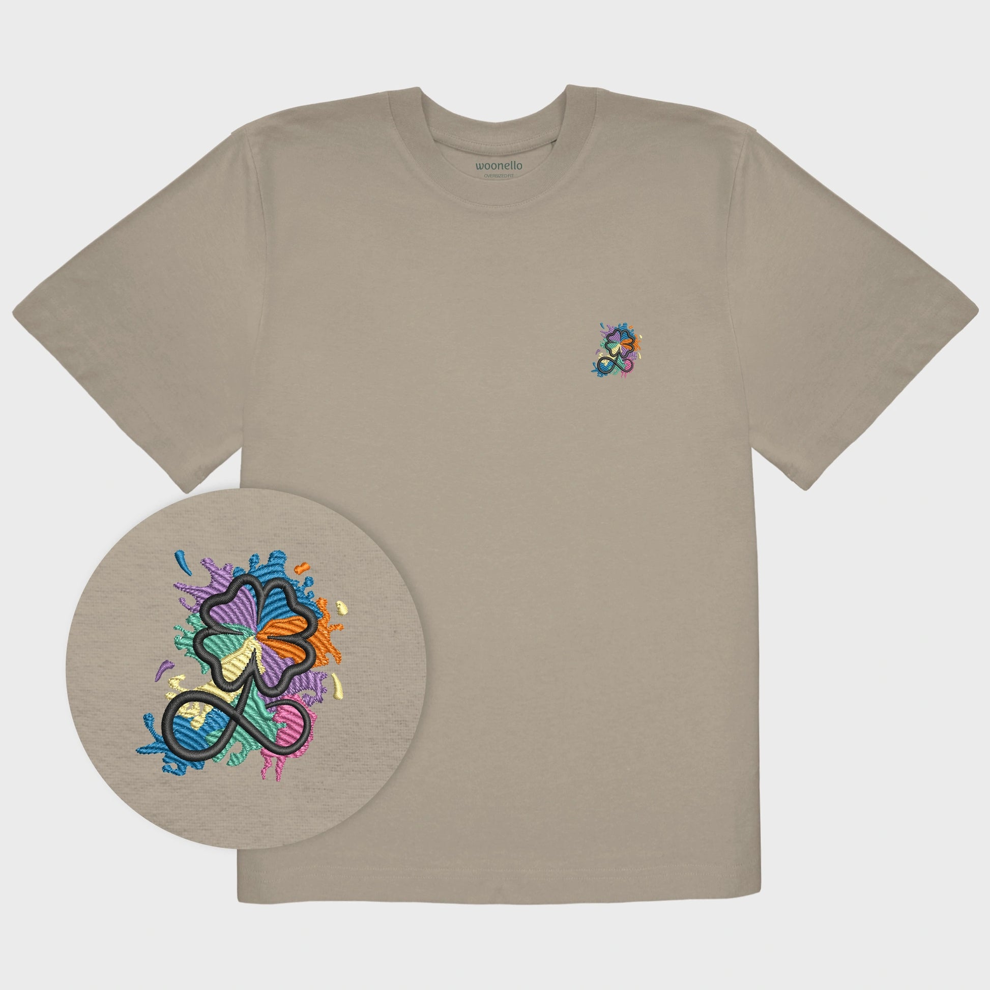 Unisex-T-Shirt Oversize mastic mit bestickter Brustpartie, Fokus auf Design, Kleeblatt-Infinity-Logo im mehrfarbigen Farbspritzer-Design
