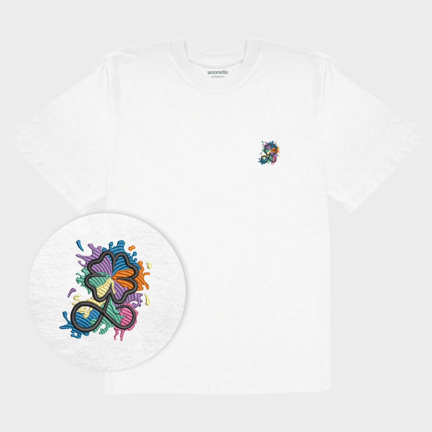 Unisex-T-Shirt Oversize weiß mit bestickter Brustpartie, Fokus auf Design, Kleeblatt-Infinity-Logo im mehrfarbigen Farbspritzer-Design