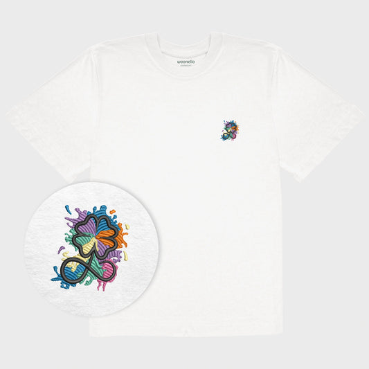 Unisex oversize white T-shirt with embroidered chest design, focus on design, clover infinity logo in multicolored paint-splash style