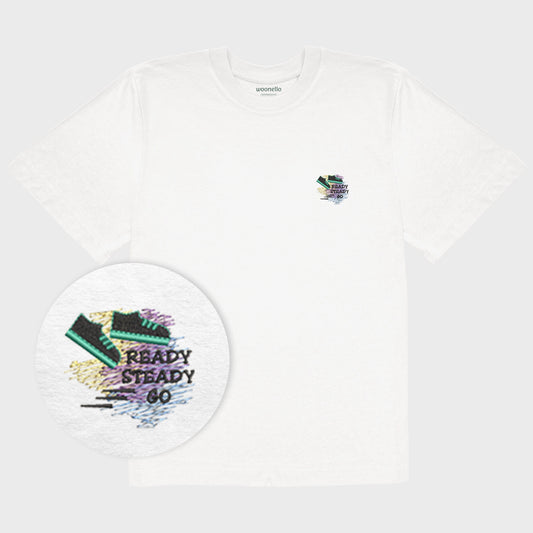 Unisex oversize white T-shirt with embroidered chest design, focus on design, outline drawing of a sneaker with motion lines in the background