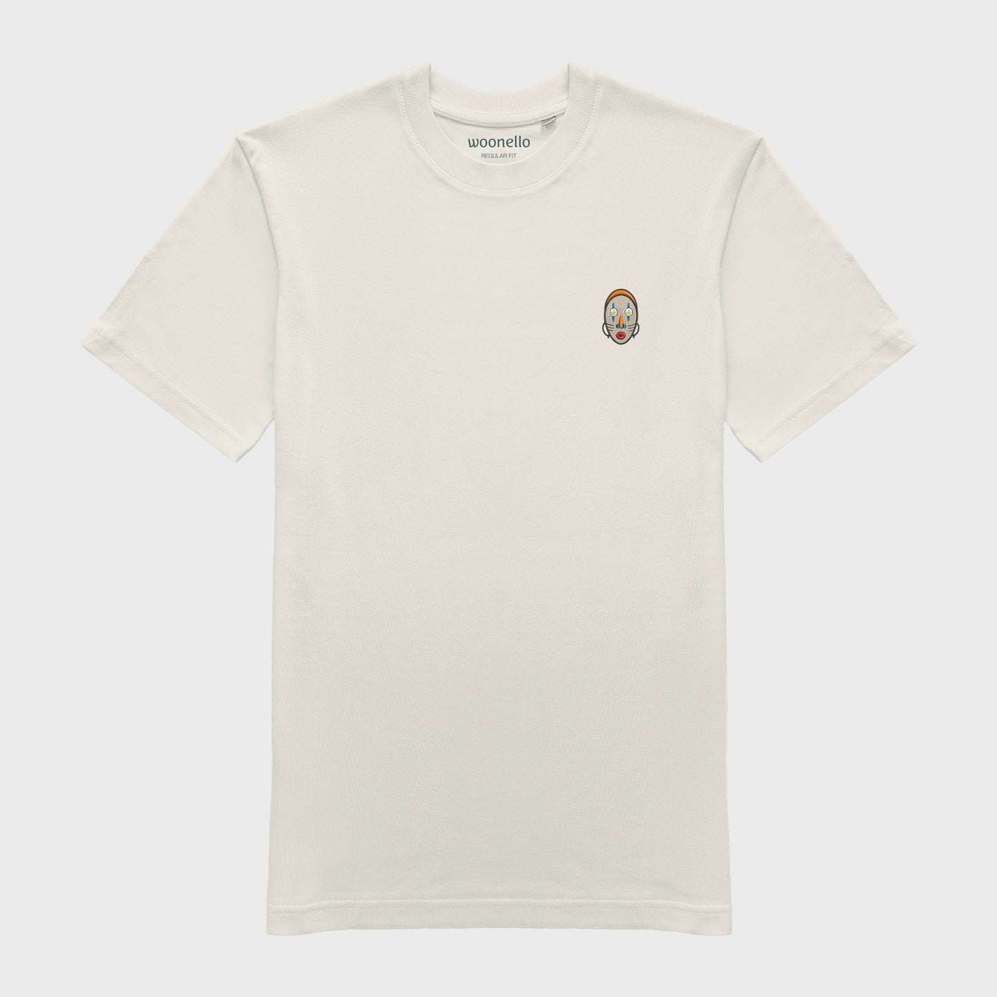 Unisex-T-Shirt cremeweiß mit bestickter Brustpartie, abstraktes afrikanisches Maske mit halbmondförmigen Augen
