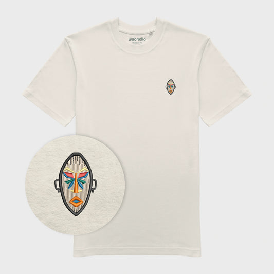 Unisex off white T-shirt with embroidered chest design, focus on design, African mask with symmetrical facial features and geometric shapes