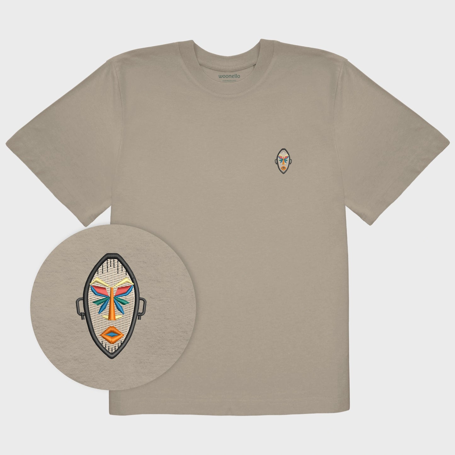 Unisex oversize mastic T-shirt with embroidered chest design, focus on design, African mask with symmetrical facial features and geometric shapes