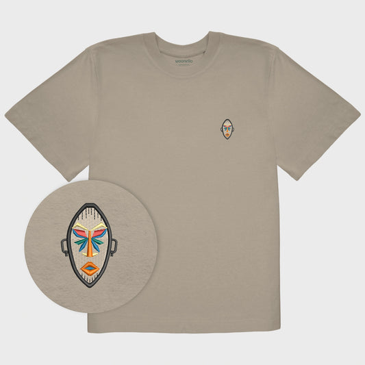Unisex oversize mastic T-shirt with embroidered chest design, focus on design, African mask with symmetrical facial features and geometric shapes