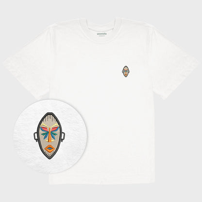 Unisex oversize white T-shirt with embroidered chest design, focus on design, African mask with symmetrical facial features and geometric shapes