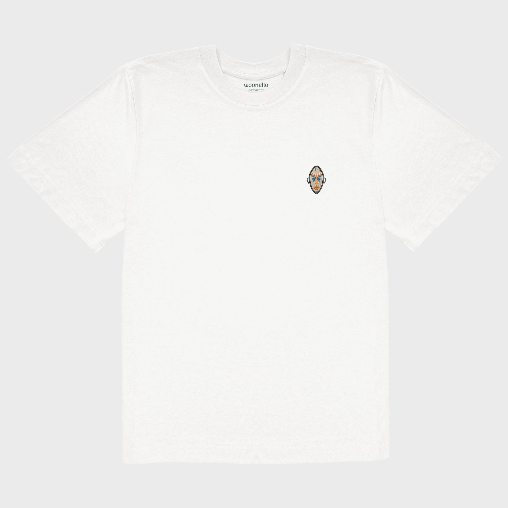 Unisex oversize white T-shirt with embroidered chest design, African mask with symmetrical facial features and geometric shapes