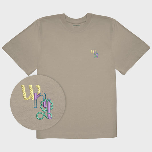 Unisex oversize mastic T-shirt with embroidered chest design, focus on design, WNL logo (short for Woonello) with clover infinity symbol