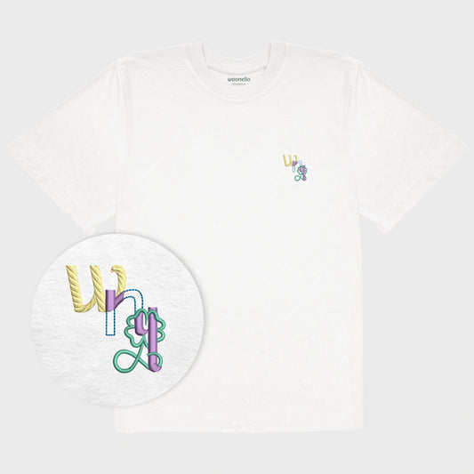Unisex oversize white T-shirt with embroidered chest design, focus on design, WNL logo (short for Woonello) with clover infinity symbol